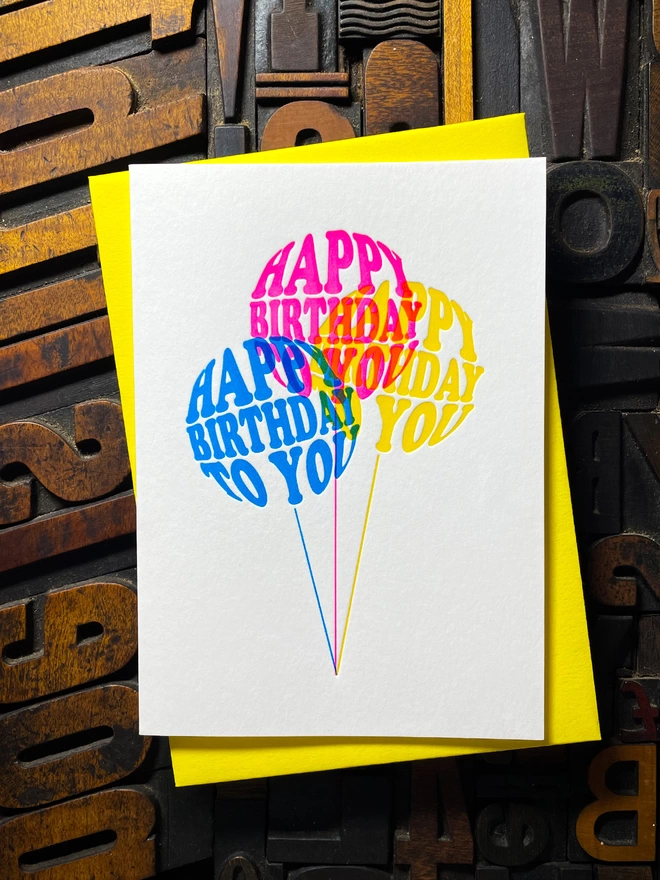 Birthday card with typographic design on three colourful balloons letterpress card. Deep impression print. Unique with no print being the same. They show slight colour variations adding to the style comes with premium quality colourful envelopes.