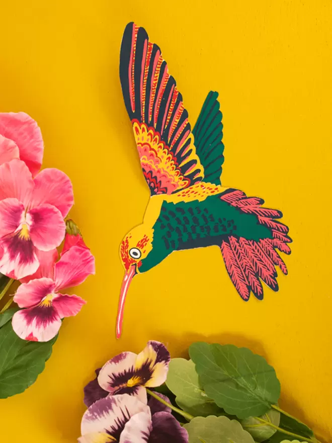 Full shot of image of pink and green hummingbird