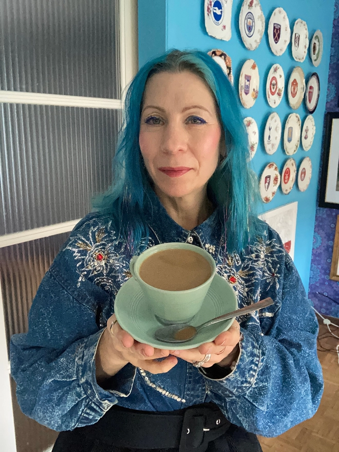 A pale green 1940s cup and saucer from the company Beryl Ware. The cup is filled to the brim with resin ‘tea’. There is a tea spoon in the saucer which has a drop of resin tea in its bowl.