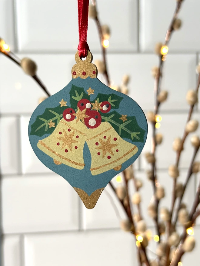 Laser cut wooden bauble shapes which have been hand painted with one christmas candle design and one with a festive bell design. Using blue, yellow, green, red and gold paint.