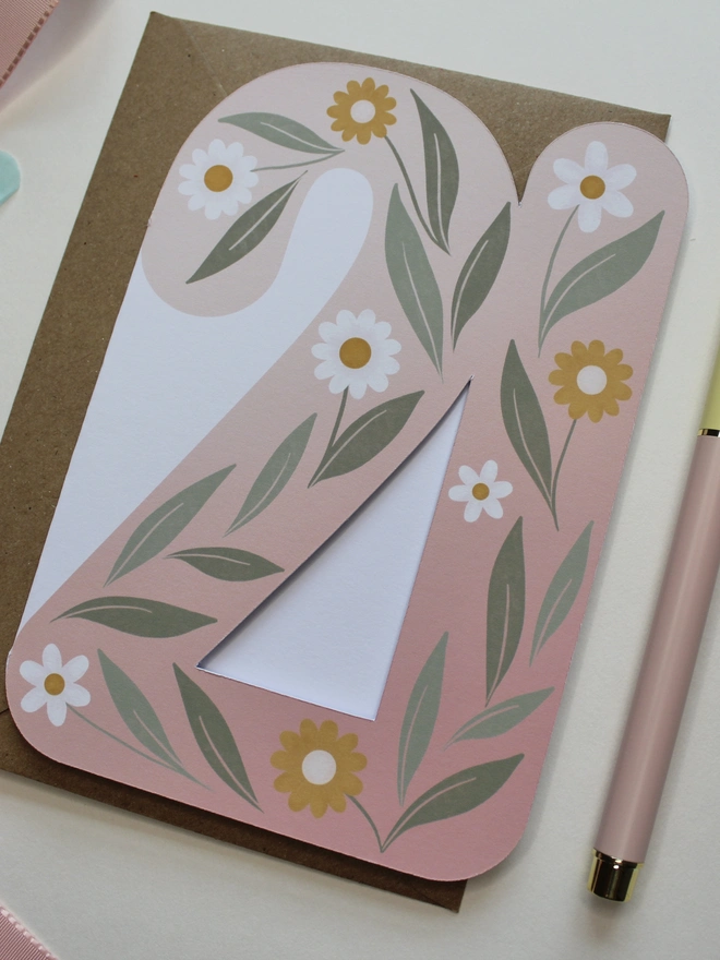floral 21st birthday card. card shaped like number 21 with illustrated flowers and leaves.