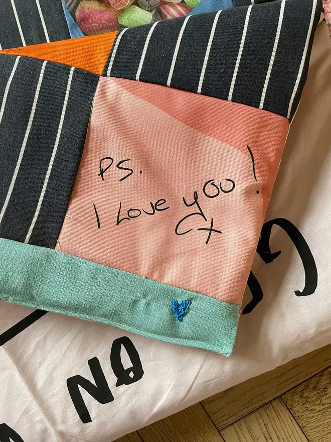 If you have handwritten notes I can turn them into a really beautiful fabric square. Here we used the soft fabric of a chef's apron to make up the majority of the quilt, my heart broke as I sewed it. 