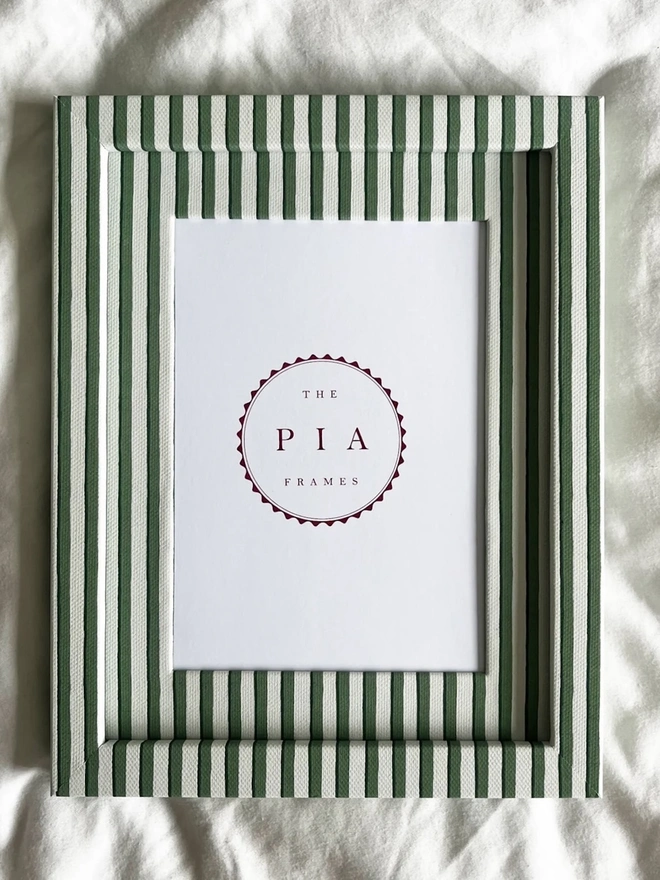 Green Vanguard Stripe Frame, a colourful striped frame sitting on a plain white surface. 