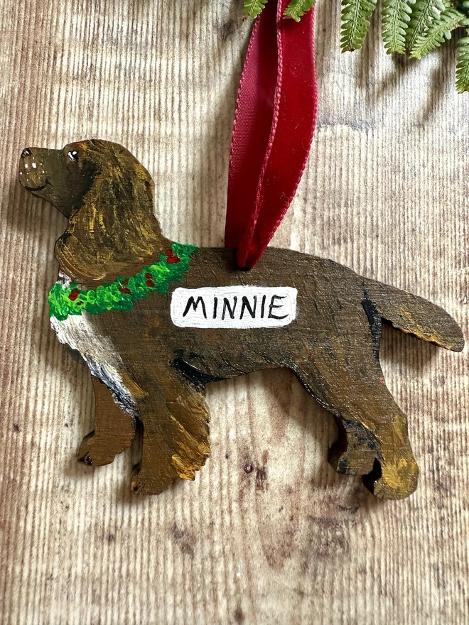 Working Cocker Handpainted Christmas Decoration in Chocolate Brown with the name Minnie painted on and hung with red velvet ribbon 