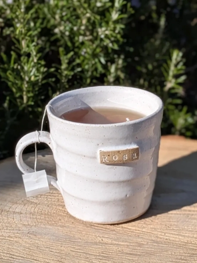 Personalised Ceramic Tea Mug. A mug in rustic white.