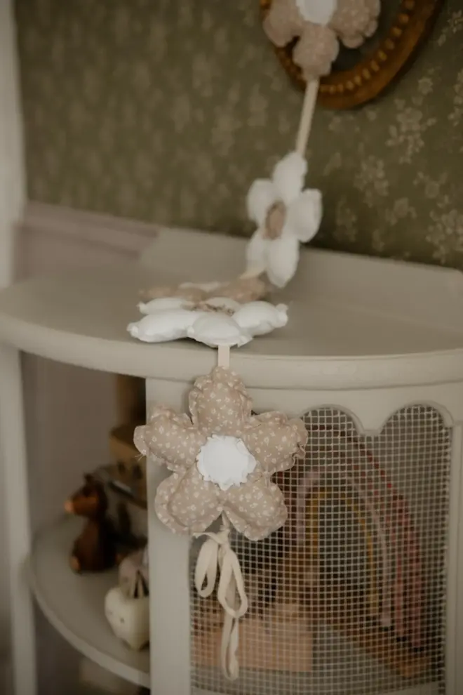 Daisy Flower Garland Decoration, a hanging colourful daisy flower garland sitting in a child's bedroom. 