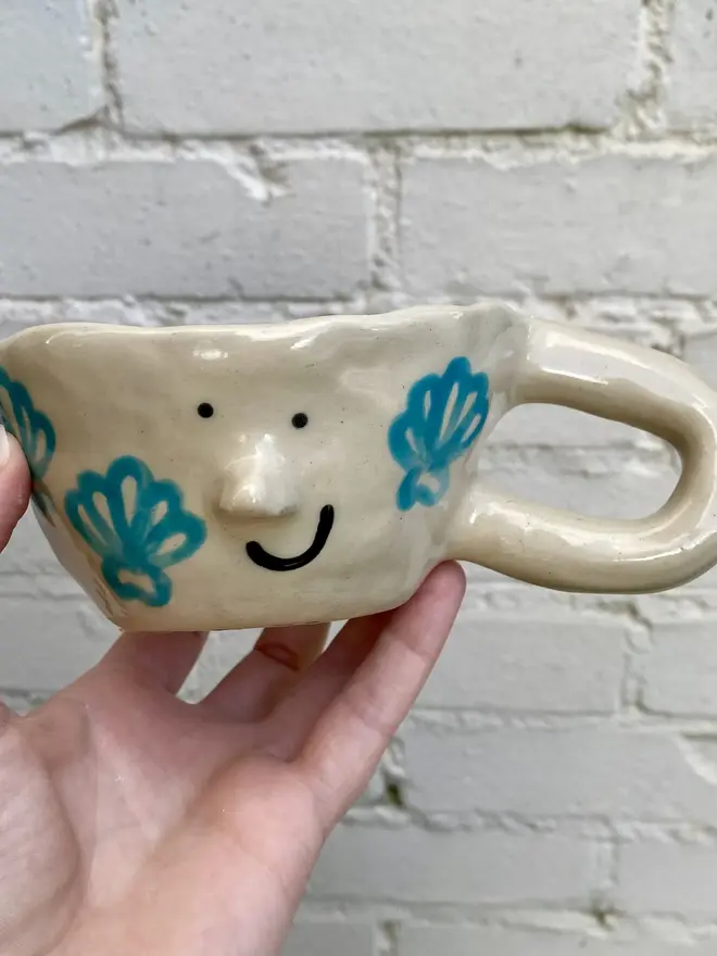 handmade ceramic smiley face shell mug