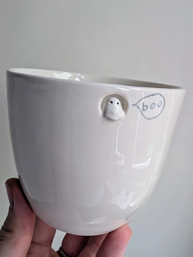 white ceramic Halloween ghost beaker with a speech bubble with boo 