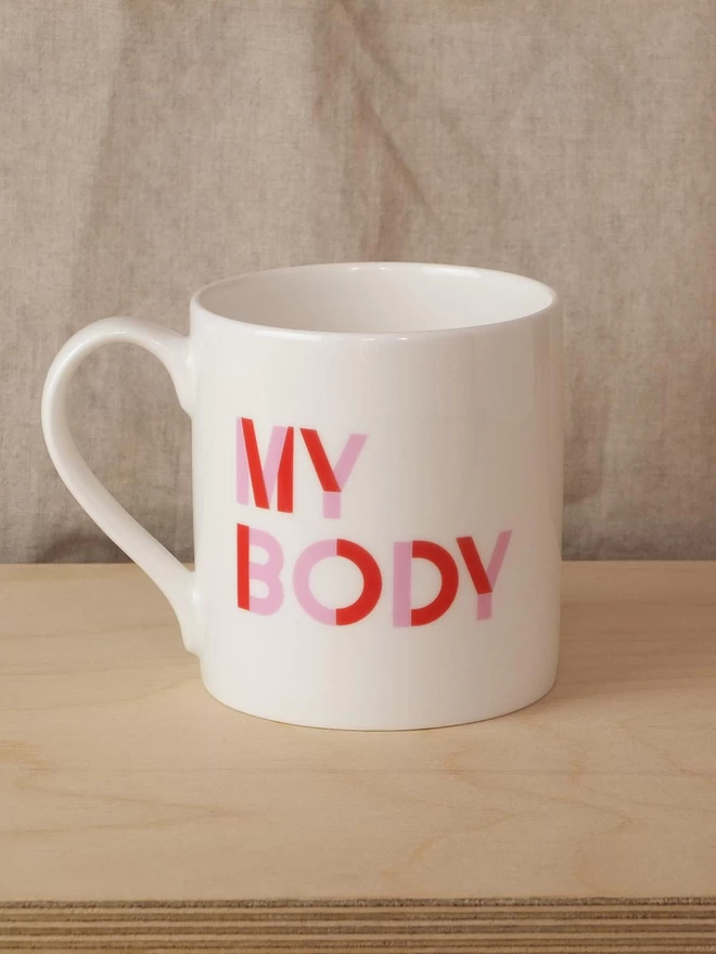 Black & Beech white mug with My Body written on one side and My Choice on the other in Pink and Red 