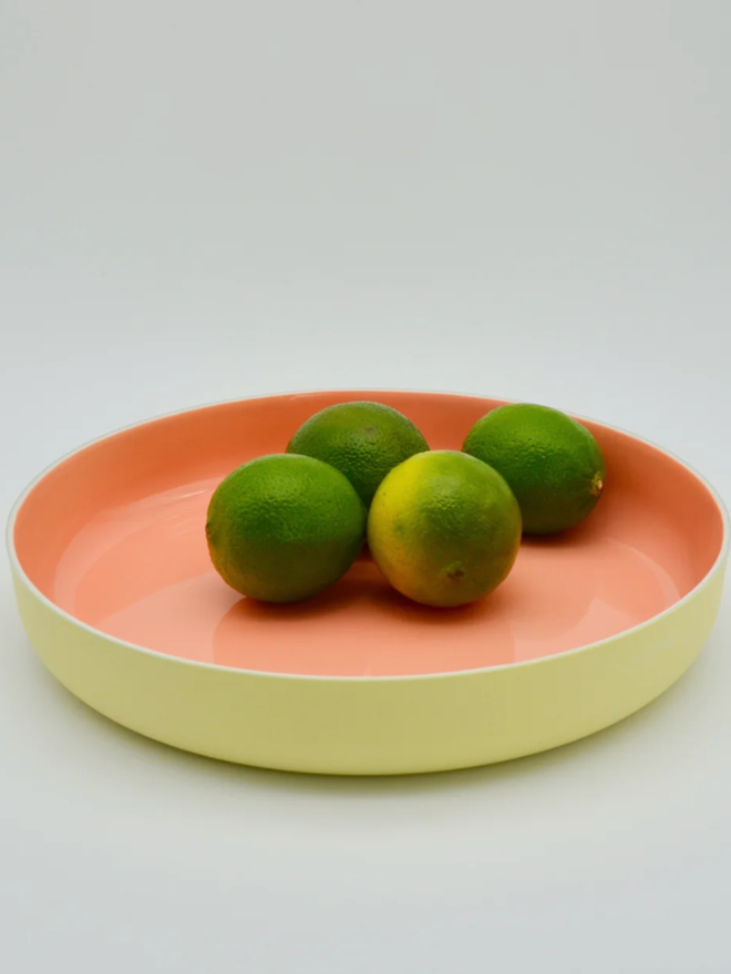 Serving Plate. A yellow serving plate with pink interior.
