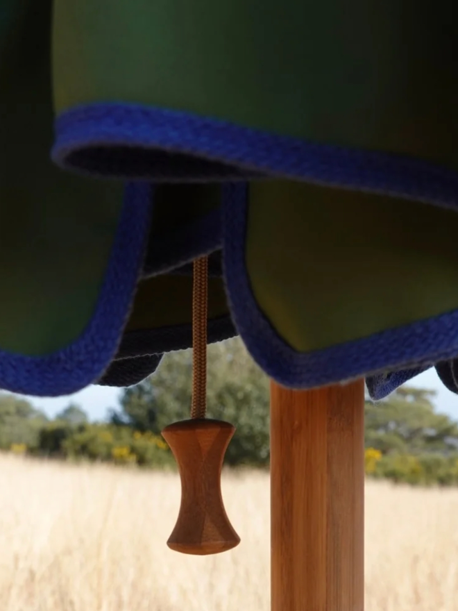 Parasol with Contrast Colour Trim. A parasol in olive green with blue trim