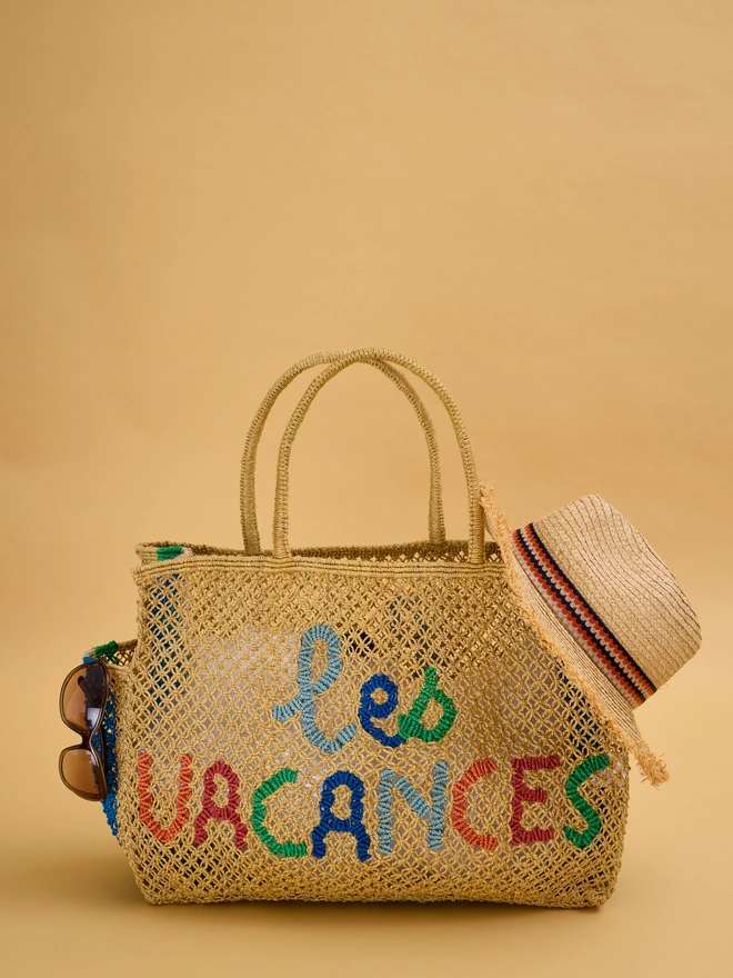 mustard coloured jute bag with multicoloured wording 'les vacances'