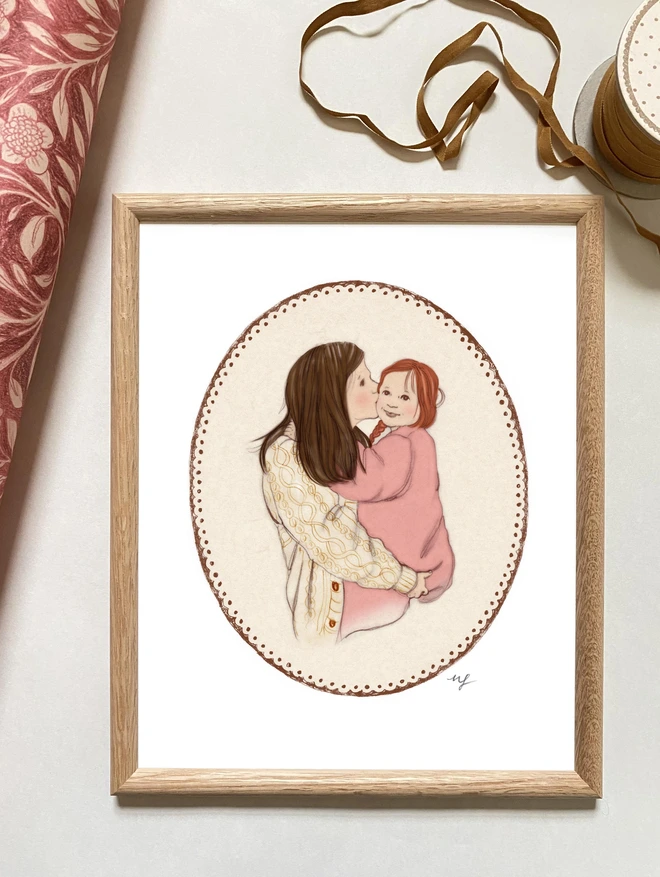 a photo of a framed art print of a personalised drawing of a mother holding her daughter drawn in a vintage storybook style framed in a retro oak frame