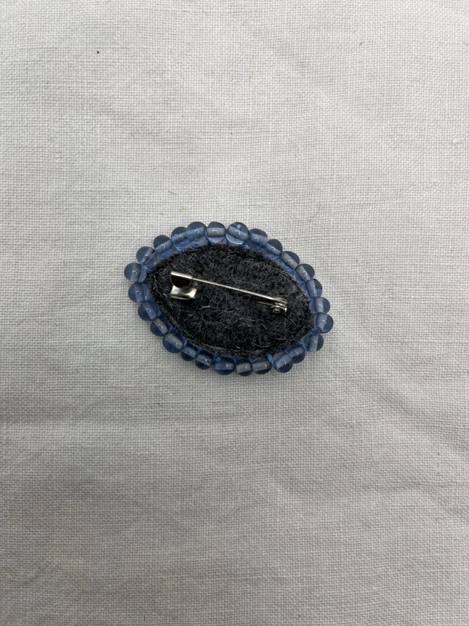 back of blue eyes brooch