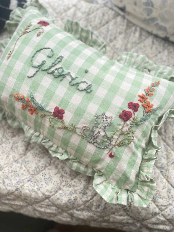 Green gingham embroidered cushion with cat design 