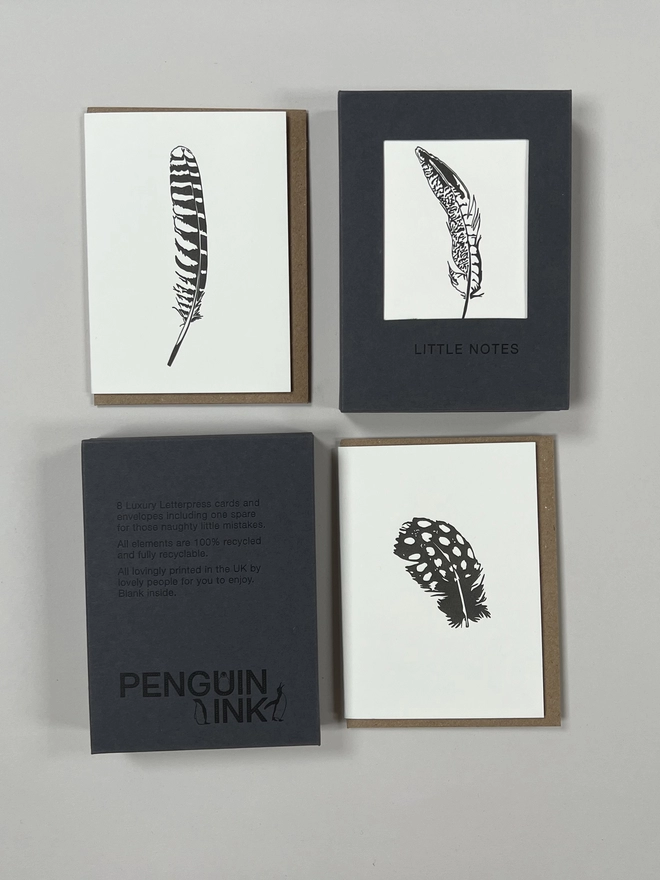 Closed feather gift boxes that have eight note cards and nine envelopes for those naughty little mistakes