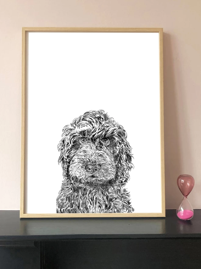 Art print of a hand drawn portrait of a Labradoodle dog displayed in a frame