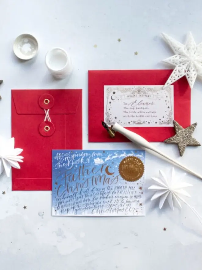 A blue gold foil certificate beside red envelopes, one with a "Special Delivery" label addressed to Eleanor.