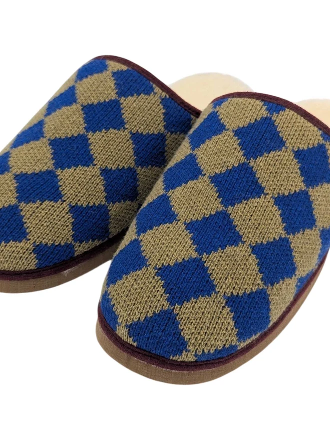 Lambswool & Sheepskin Slippers, a pair of colourful lambswool and sheepskin slippers sitting on a plain white surface. 