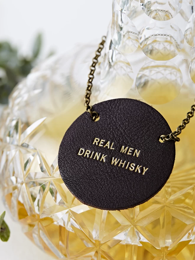 Chocolate brown 'real men drink whisky' tag.