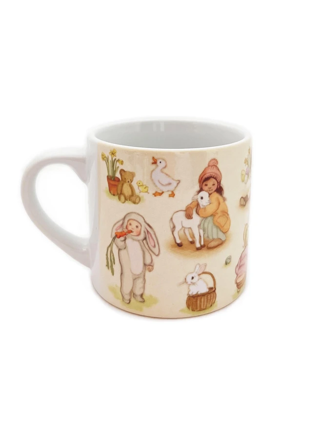 a small ceramic Easter mug with a traditional easter scene