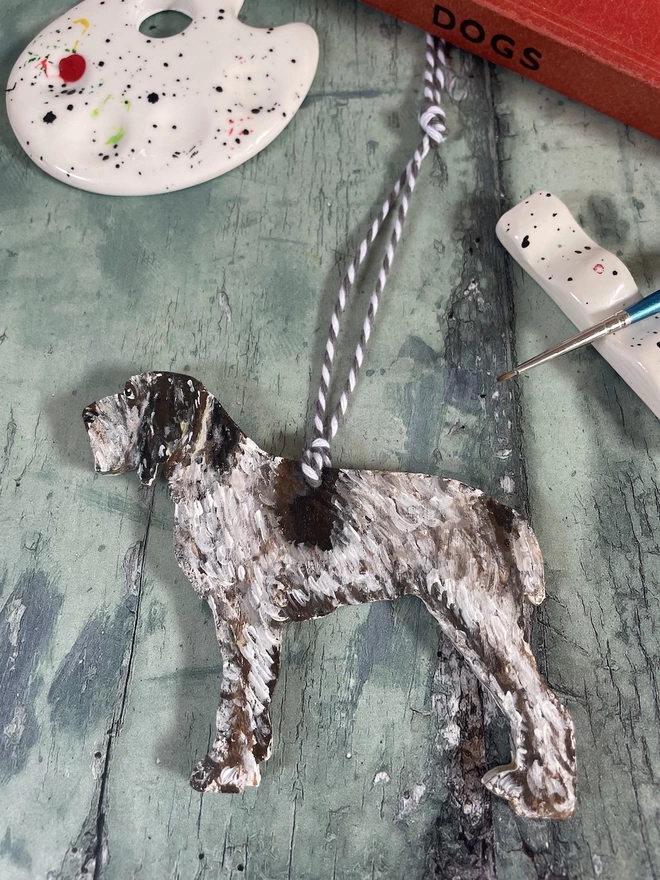 Italian Spinone hand- painted dog decoration with paintbrush and paint palette in the background