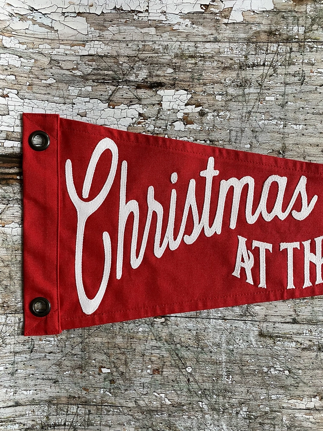A section of a red flag showing the words Christmas at the