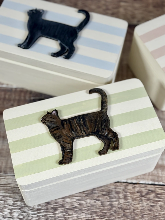 sage green and cream striped small wooden keepsake box with a hand - painted wooden tabby cat 