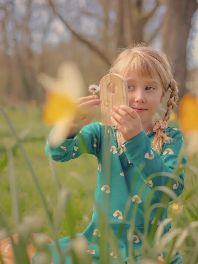 child playing with wooden fairy door