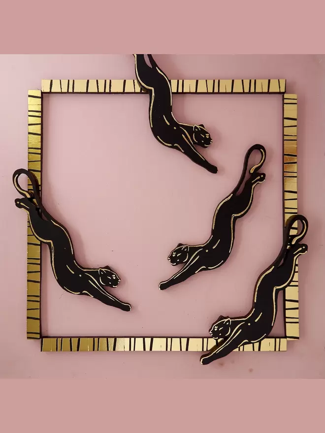 black panther earrings pink background