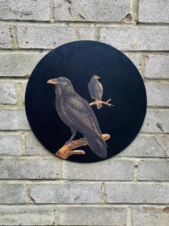 Round, black wall art with ravens