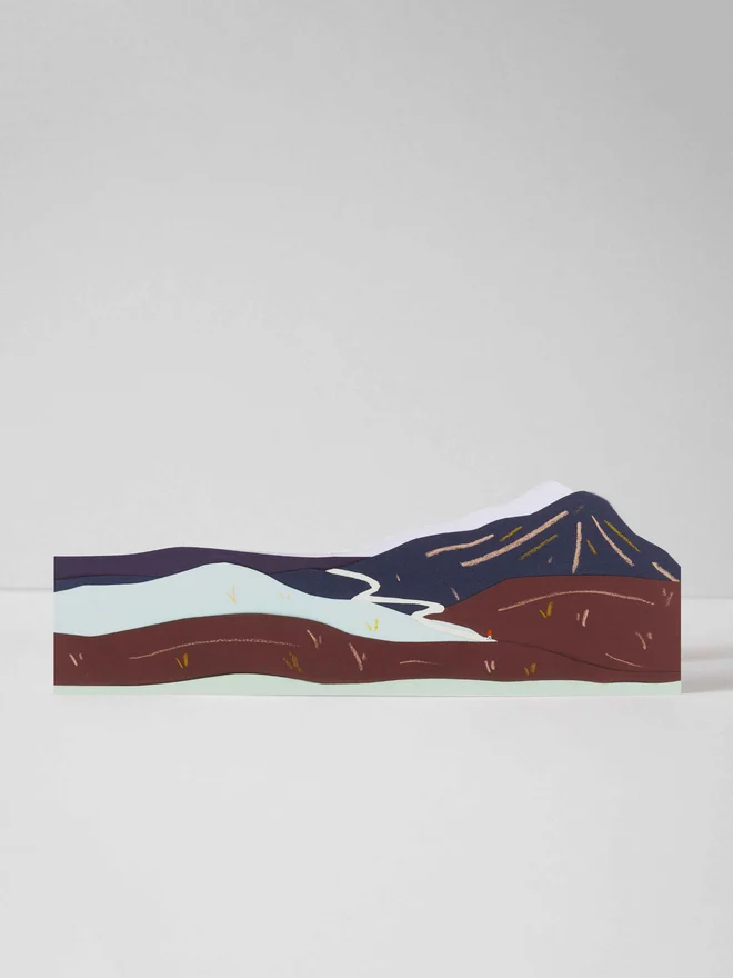 A cut out card of a mountain