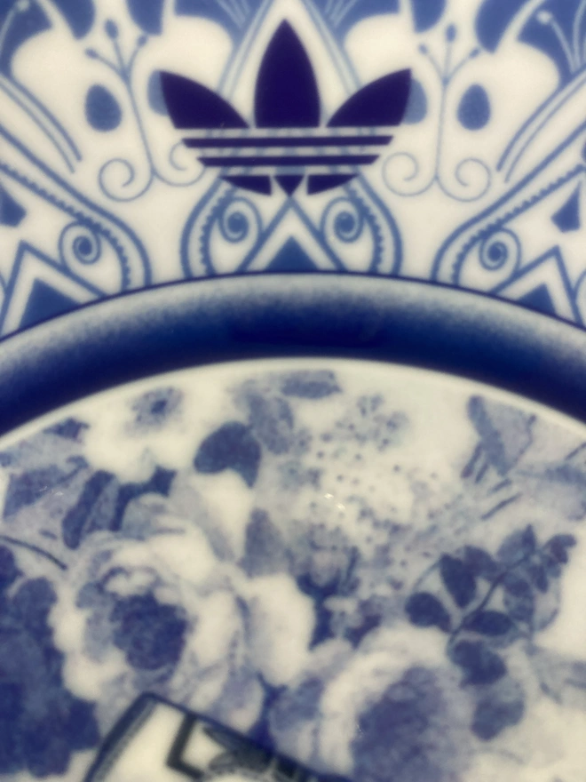 detail of the plate showing the Adidas trefoil logo which decorates the plate