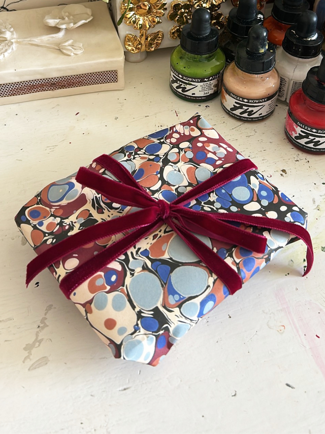 Lucy Deaner marbled gift wrap with velvet ribbon