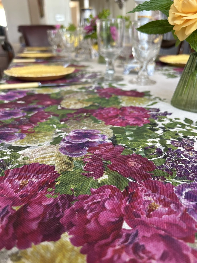Rich floral tablecloth covered in hand painted roses, perfect for a wedding or summer celebration dinner