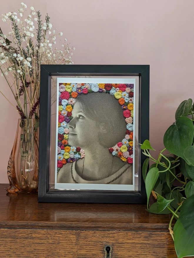 Vintage photo of lady surrounded by embroidered flowers print in fram