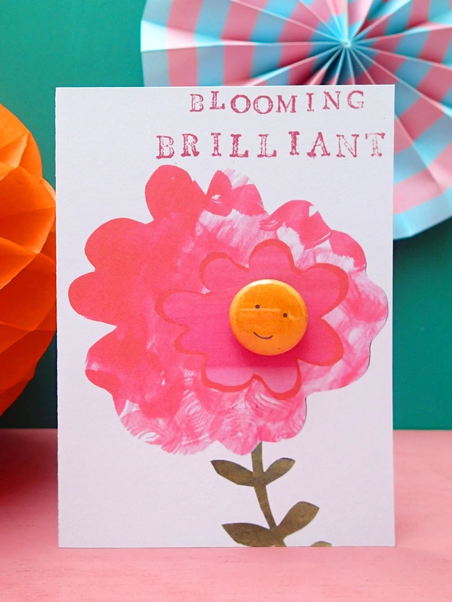 brilliant pink flower greeting card with happy face pin badge