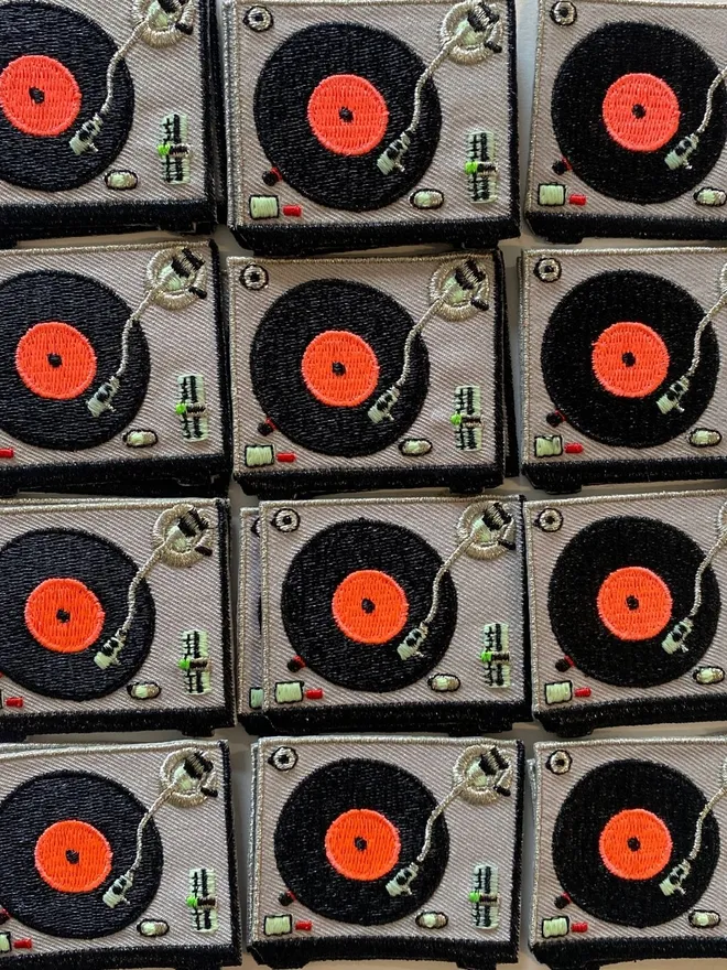 Embroidered record player iron on fabric patch.