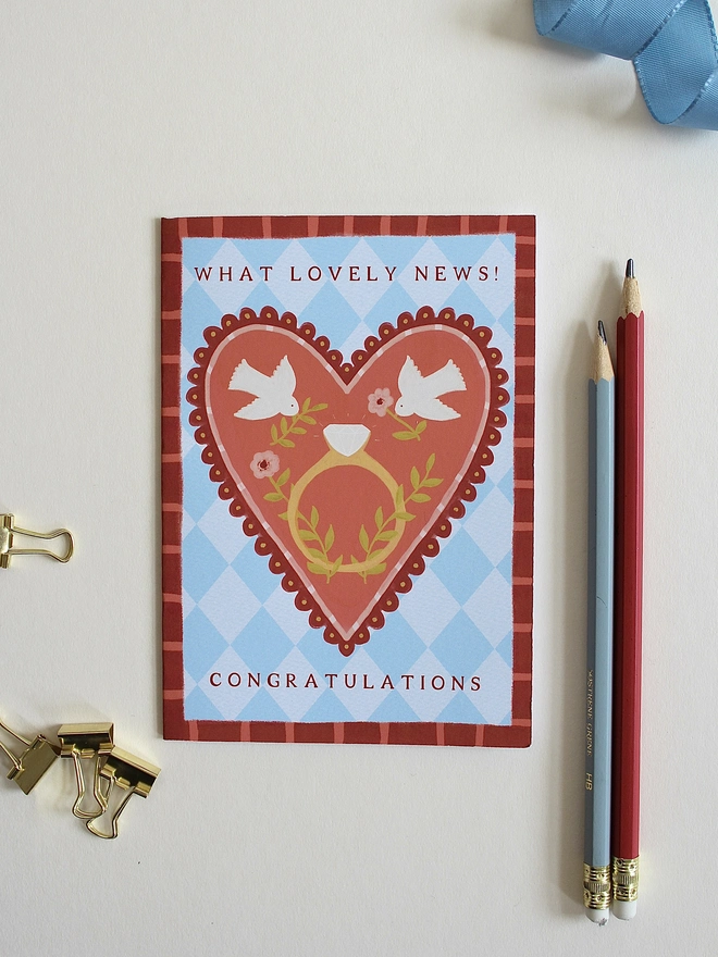 botanical engagement card featuring love birds on a big heart with a ring