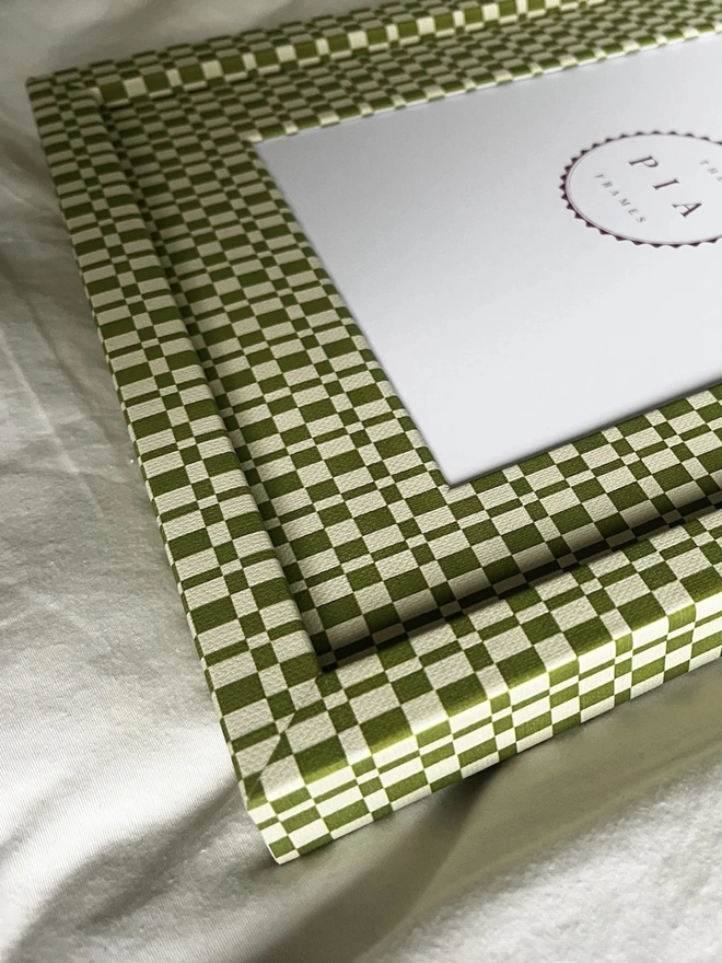 Green & Beige Checkered Frame, a colourful frame sitting on a plain white surface. 