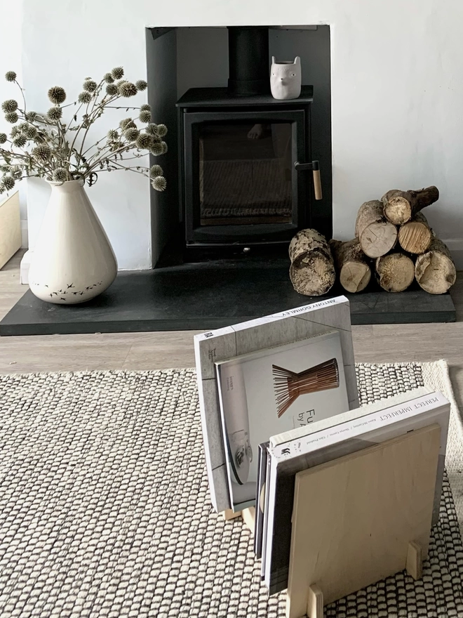 flip on carpet with large coffee table books stacked inside