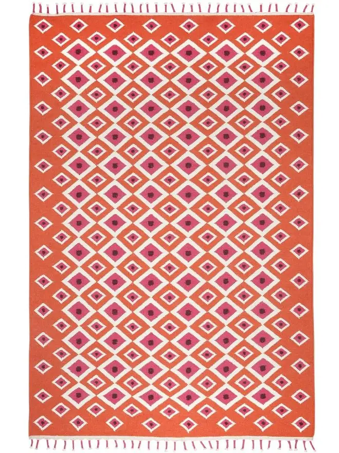 Evil Eye Flatweave Rug, a colourful rug on a plain surface. 