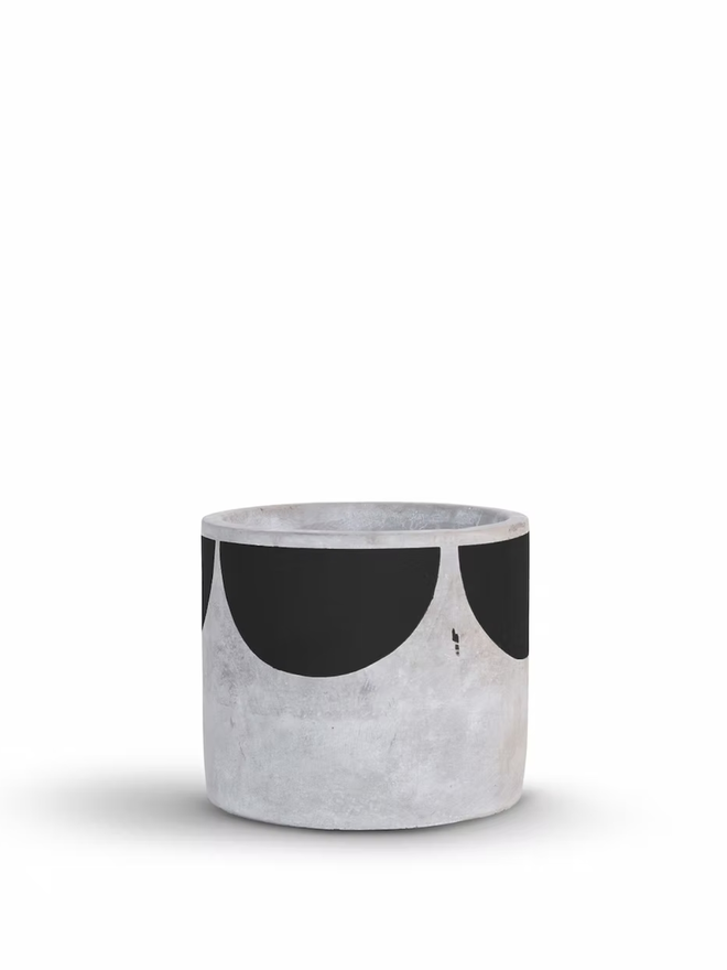 sunny concrete plant pot. a grey plant pot with a black half sun pattern painted around the top rim.