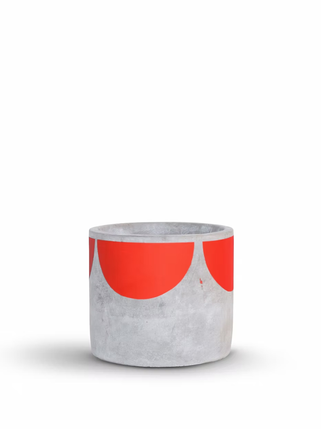 sunny concrete plant pot. a grey plant pot with a red half sun pattern painted around the top rim.