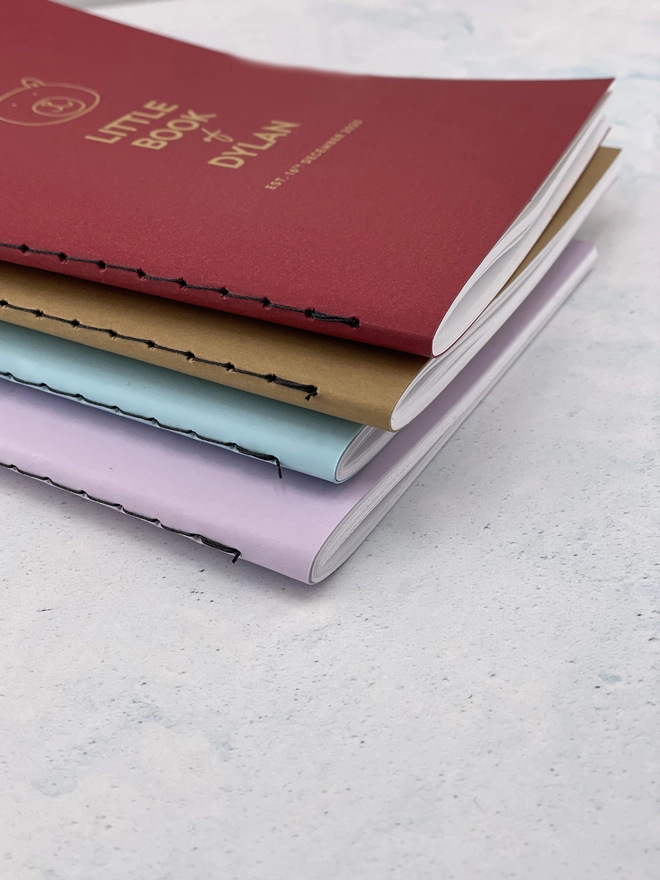 a set of four notebooks with a sewn bind