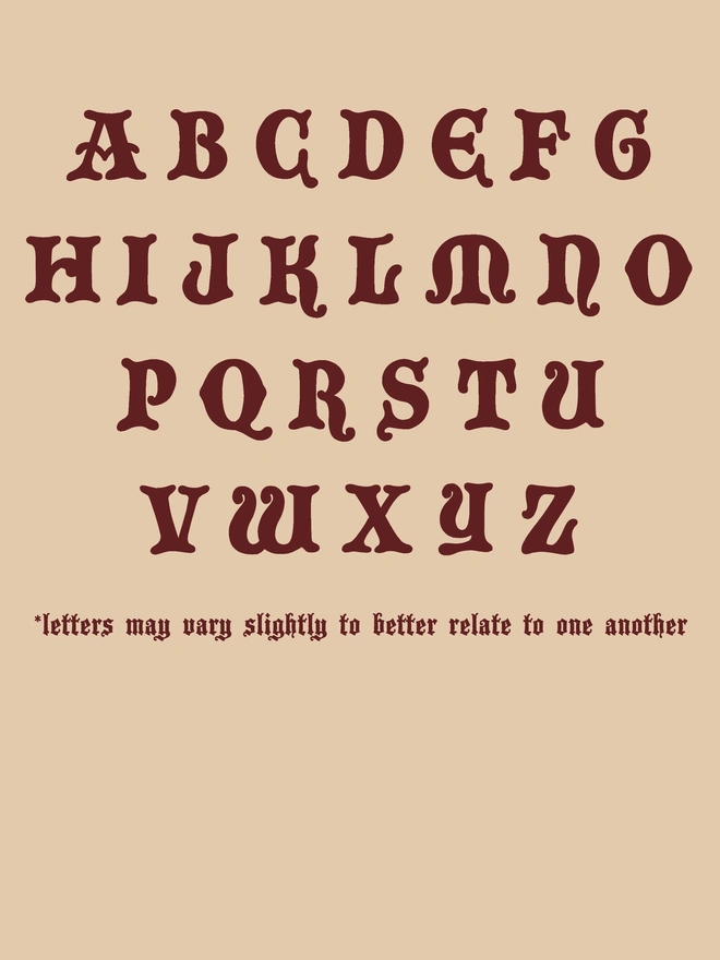 Red lettering on a cream background - a medieval style alphabet.