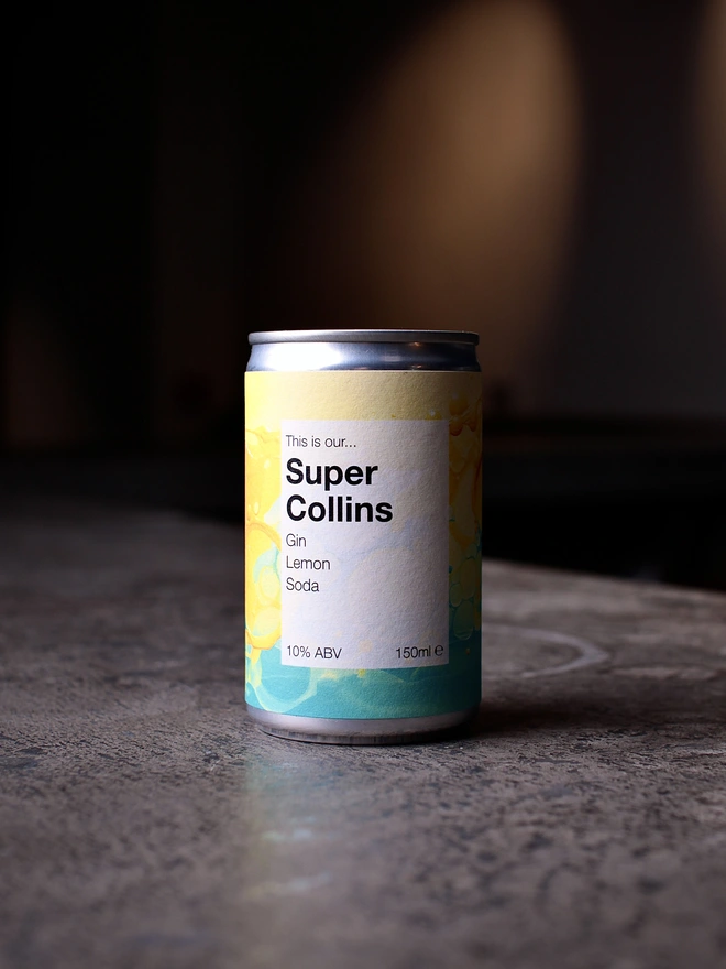 Can of Super Collins on concrete, shot against a dark background 