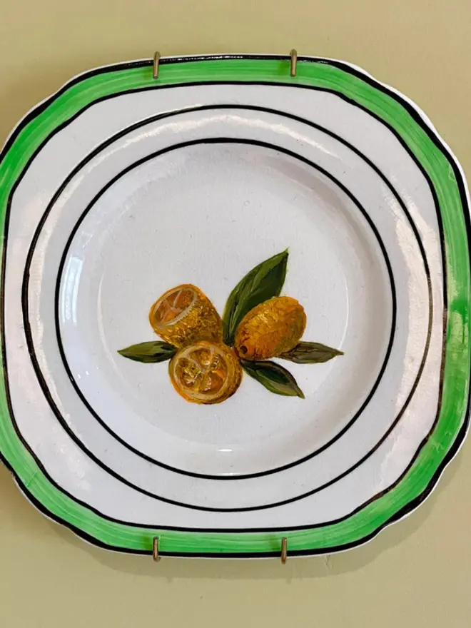 Oil Painted Kumquats On A 1940s Tea Plate, against a beige background. 