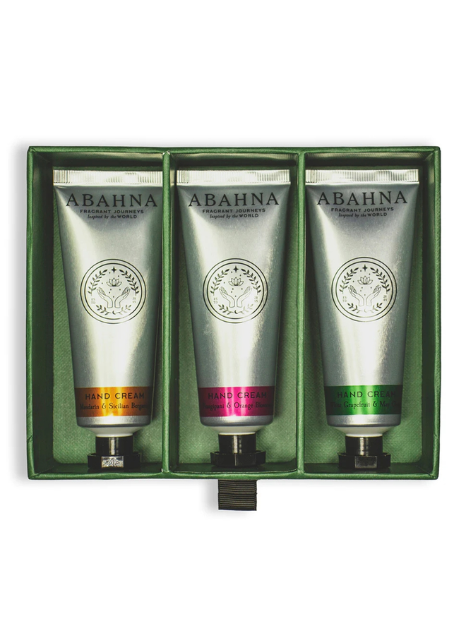 botanical hand cream trio gift set. a green gift box containing three silver tubes of hand lotion.