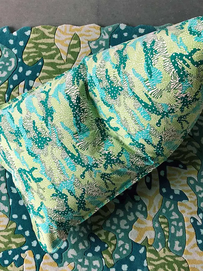 Green Big Cat Camo Bean Bag Cover, a green bean bag cover sitting on a decorated rug. 